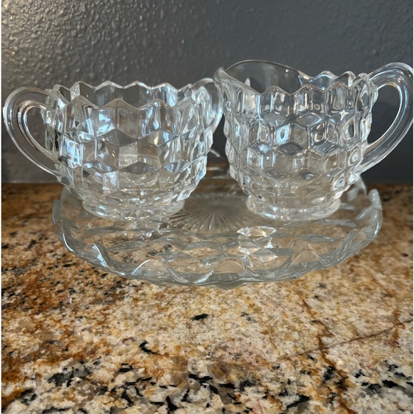 Glass vintage collectible creamer and sugar on a glass plate